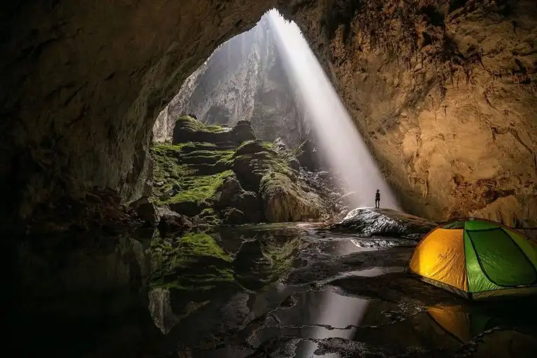 Tent inside Son Doong Cave with sunlight streaming through the cave opening