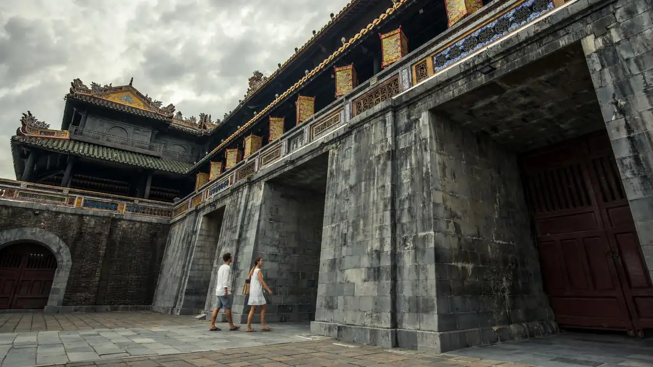 A couple on a private tour walking through Ngo Mon Gate at the Imperial City in Hue